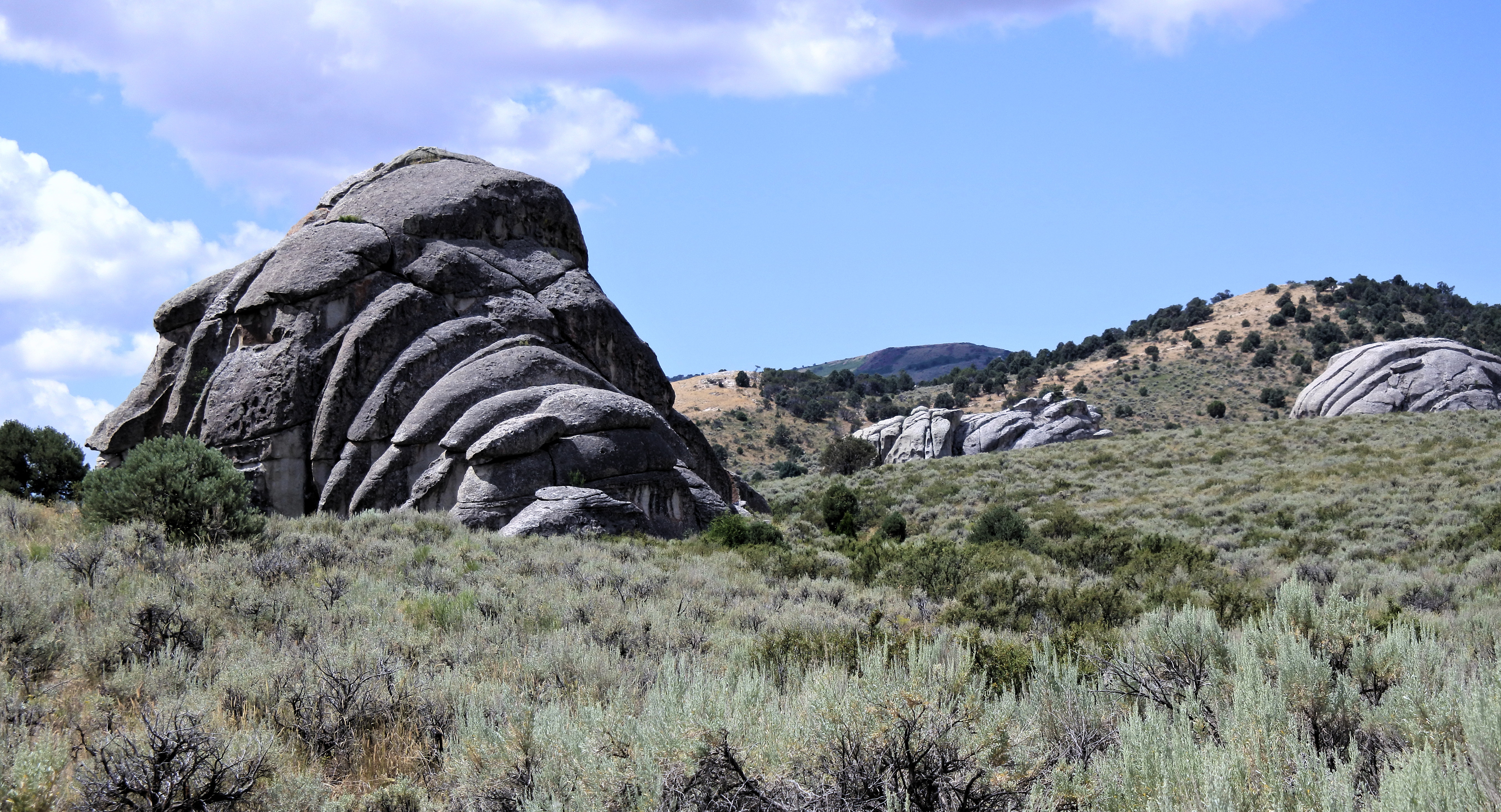 Granite domes and spires at City of Rocks National Reserve, Idaho — the stage for Theater of Shadows and Tribal Boundaries — via Wikimedia Commons (CC0)